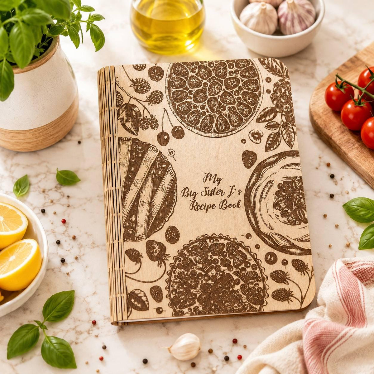 Light wooden recipe book with engraved flowers and kitchen motifs