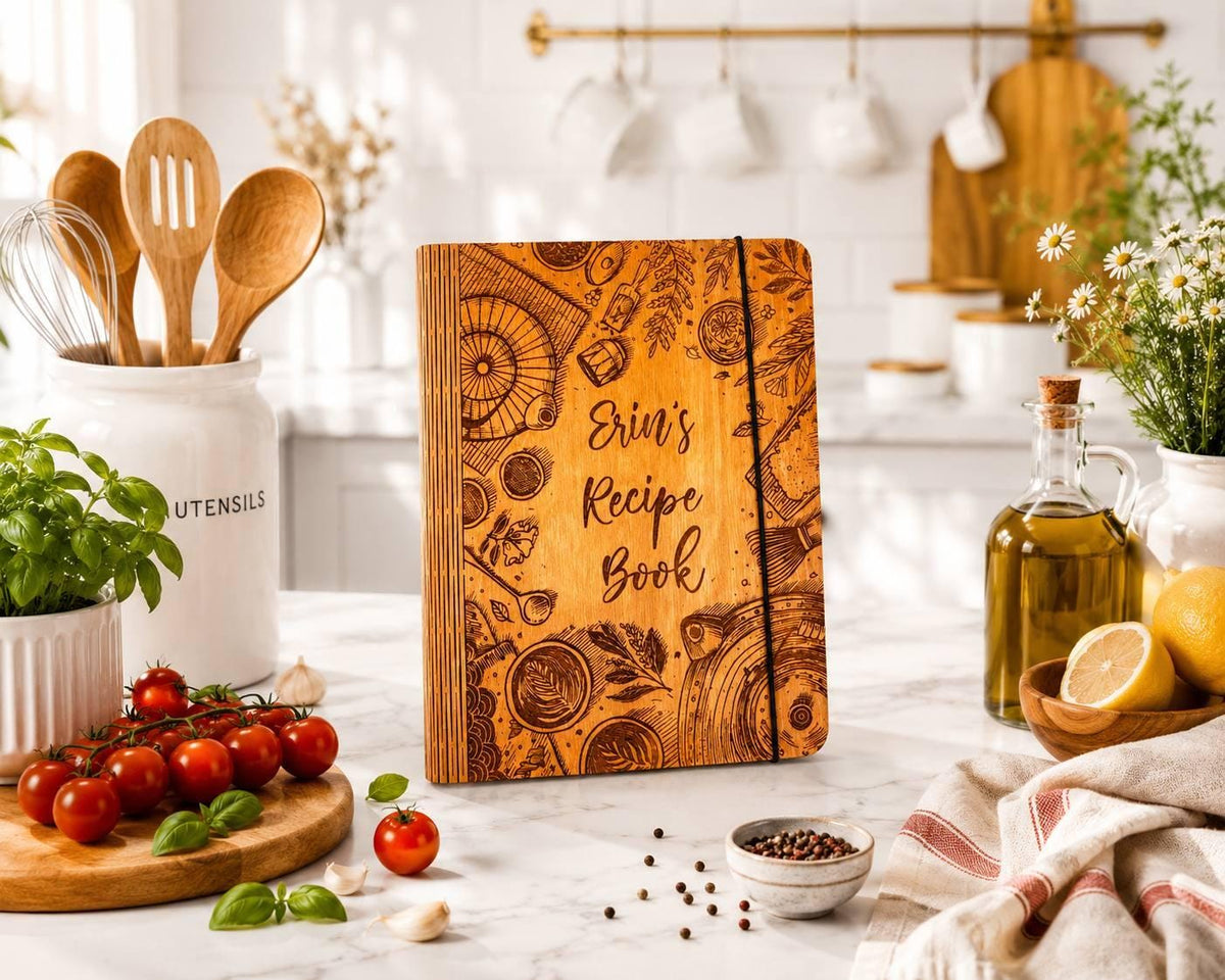 Personalized wooden recipe book with engraved kitchen illustrations on a bright kitchen counter