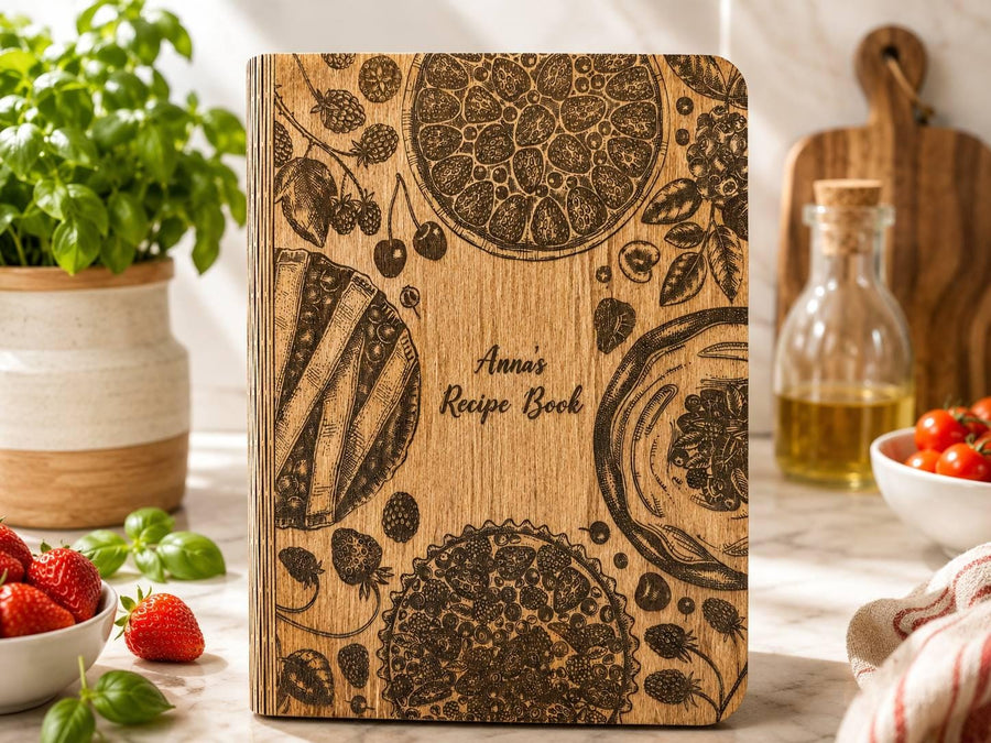 Anna's engraved wooden recipe book with botanical and kitchen illustrations
